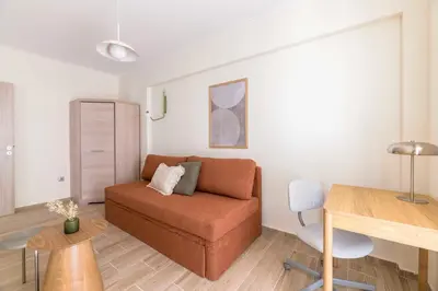 a living room with a couch and a table at Lightstone 3BR Living in Glyfada by UPSTREET in Athens