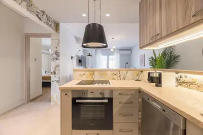 a kitchen with a stove and a counter top at Lightstone 3BR Living in Glyfada by UPSTREET in Athens