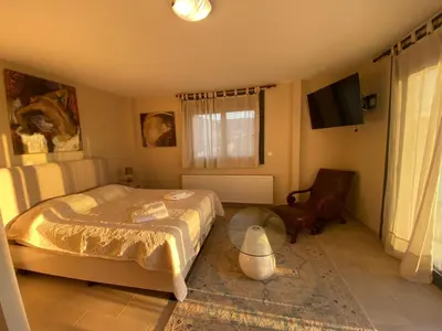 a bedroom with a bed and a tv in it at EUPHORIA Pool Villa in Porto Rafti