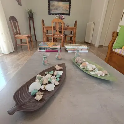 a table with two plates of flowers on it at Sunlit and cosy apartment in Athens