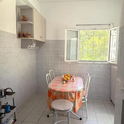 a kitchen with a table with chairs and a window at Sunlit and cosy apartment in Athens