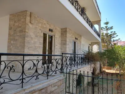 a balcony of a house with a black fence at Sunlit and cosy apartment in Athens