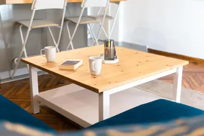 a wooden coffee table with two cups on it at Your peaceful corner in the city in Athens