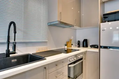 a kitchen with a sink and a refrigerator at Your peaceful corner in the city in Athens