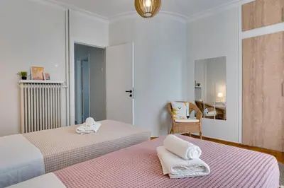 a bedroom with two beds with towels on them at Your peaceful corner in the city in Athens