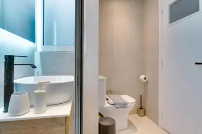 a bathroom with a sink and a toilet at Your peaceful corner in the city in Athens