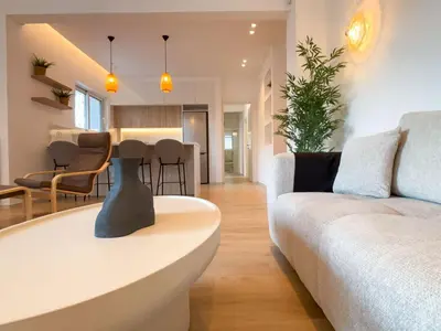 a living room with a couch and a table at Bright & Airy Flat in Voula Center in Athens