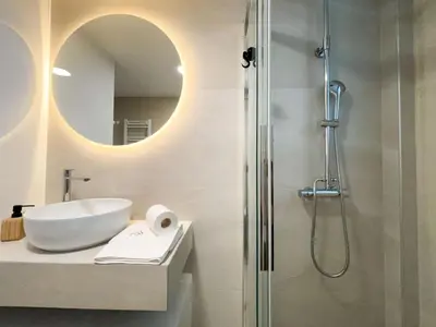 a bathroom with a sink and a shower at Bright & Airy Flat in Voula Center in Athens