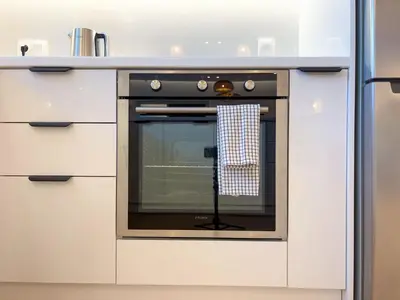 a kitchen with an oven in a white kitchen at Bright & Airy Flat in Voula Center in Athens