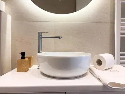 a white bowl sink on a counter in a bathroom at Bright & Airy Flat in Voula Center in Athens