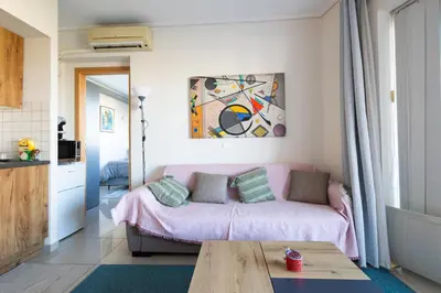 a living room with a couch and a table at Nancy view apartment in Markopoulo