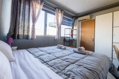 a bedroom with a large bed with towels on it at Nancy view apartment in Markopoulo