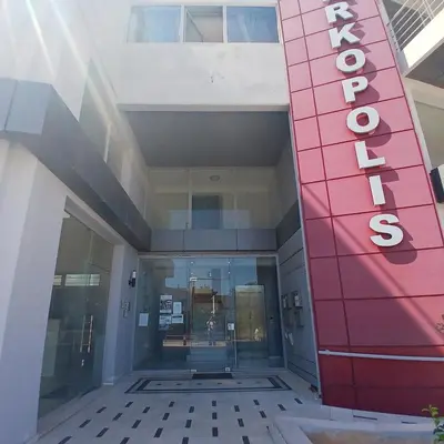 an entrance to a building with a red sign on it at Nancy view apartment in Markopoulo