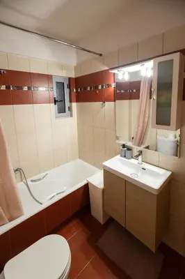 a bathroom with a tub and a toilet and a sink at Nancy view apartment in Markopoulo
