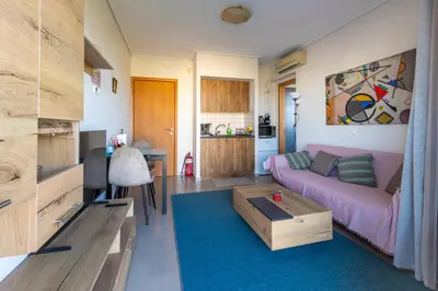 a living room with a couch and a table at Nancy view apartment in Markopoulo
