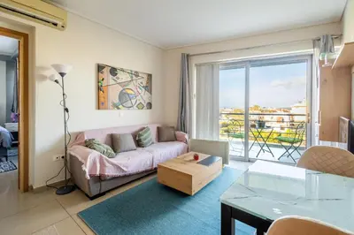 a living room with a couch and a table at Nancy view apartment in Markopoulo