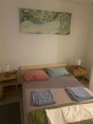 a bedroom with a bed and a painting on the wall at Center Hilton Area in Athens