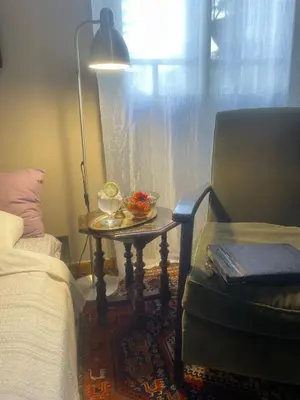 a bedroom with a table next to a bed and a lamp at Classic Athenian apartment in Athens