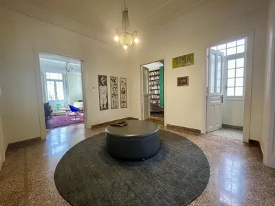 a living room with a round table in the middle at Classic Athenian apartment in Athens