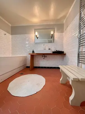 a bathroom with a sink and a bench and a mirror at Classic Athenian apartment in Athens