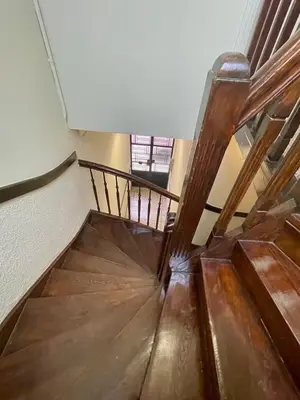 a wooden staircase in a building with a wooden floor at Classic Athenian apartment in Athens