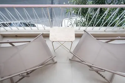 two chairs and a table on a balcony at 2BR Beatiful Apt In Thissio Near Agora & Acropolis in Athens