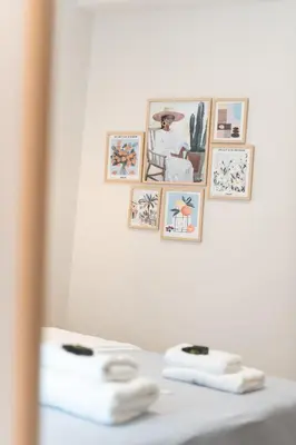 a group of pictures hanging on a wall with towels at 2BR Beatiful Apt In Thissio Near Agora & Acropolis in Athens