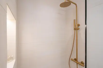 a shower with a glass door in a bathroom at 2BR Beatiful Apt In Thissio Near Agora & Acropolis in Athens