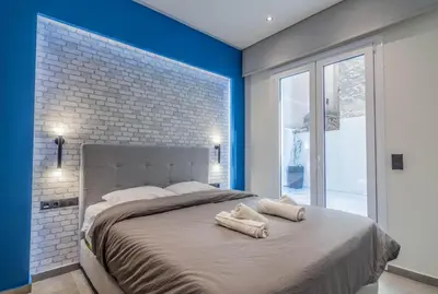 a bedroom with a large bed with towels on it at Luxurius Studio Near Plaka & Acropolis 1 in Athens