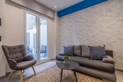 a living room with a couch and a chair at Luxurius Studio Near Plaka & Acropolis 1 in Athens