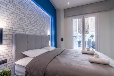 a bedroom with a large bed and a brick wall at Luxurius Studio Near Plaka & Acropolis 1 in Athens