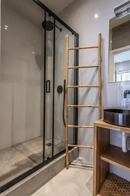 a shower with a glass door next to a sink at Luxurius Studio Near Plaka & Acropolis 1 in Athens