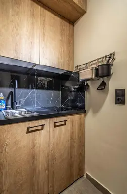 a kitchen with wooden cabinets and a sink at Luxurius Studio Near Plaka & Acropolis 2 in Athens