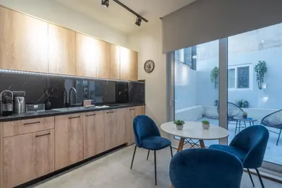 a kitchen with blue chairs and a table and a tub at Luxurius Studio Near Plaka & Acropolis 3 in Athens