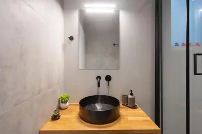 a bathroom with a large bowl sink on a wooden counter at Luxurius Studio Near Plaka & Acropolis 3 in Athens