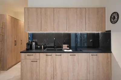a kitchen with wooden cabinets and a sink at Luxurius Studio Near Plaka & Acropolis 3 in Athens