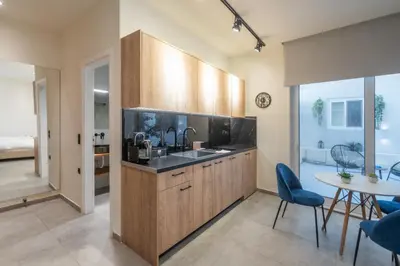 a kitchen with a sink and a table with chairs at Luxurius Studio Near Plaka & Acropolis 3 in Athens