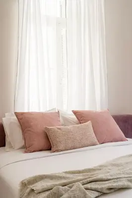 a white bed with white pillows and a window at Acropolis 1910s Neoclassical Gem Marble Bathrooms in Athens