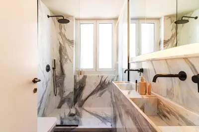 a bathroom with a tub and a sink and a shower at Acropolis 1910s Neoclassical Gem Marble Bathrooms in Athens