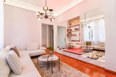 a living room with a white couch and a fireplace at Acropolis 1910s Neoclassical Gem Marble Bathrooms in Athens