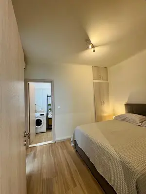 a bedroom with a bed and a door to a kitchen at Athens Nest in Athens