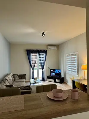 a living room with a couch and a table at Athens Nest in Athens