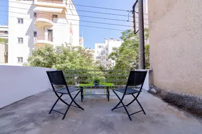 two chairs and a table on a balcony at Athens Nest in Athens