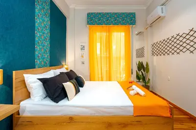 a bedroom with a bed with a teddy bear on it at Rebel's Rest - 4BR Apartment in Athens