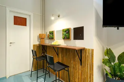 a room with a wooden bar with two chairs at Rebel's Rest - 4BR Apartment in Athens