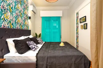 a bedroom with a bed with a blue door at Rebel's Rest - 4BR Apartment in Athens