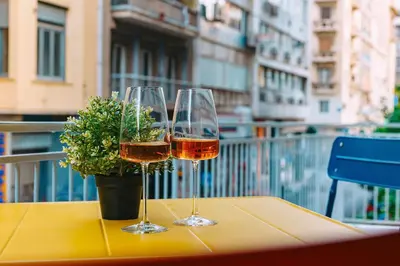 two wine glasses on a table with a potted plant at Rebel's Rest - 4BR Apartment in Athens