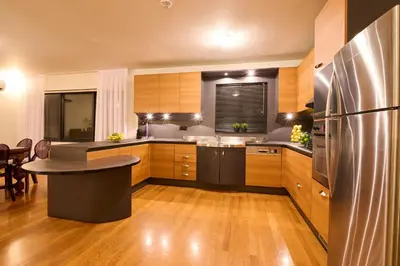 a kitchen with wooden cabinets and a stainless steel refrigerator at Ma Maison No9 Downtown Villa,Jacuzzi,5bdrs,Parking in Athens