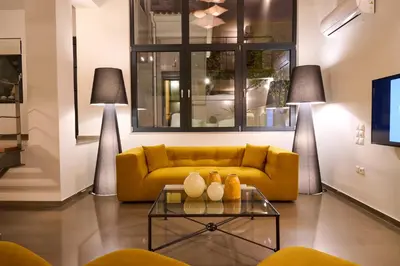 a living room with a yellow couch and a table at Ma Maison No9 Downtown Villa,Jacuzzi,5bdrs,Parking in Athens