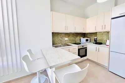 a kitchen with white cabinets and white appliances at Downtown Bliss - Piraeus Street by ΜΡS in Athens